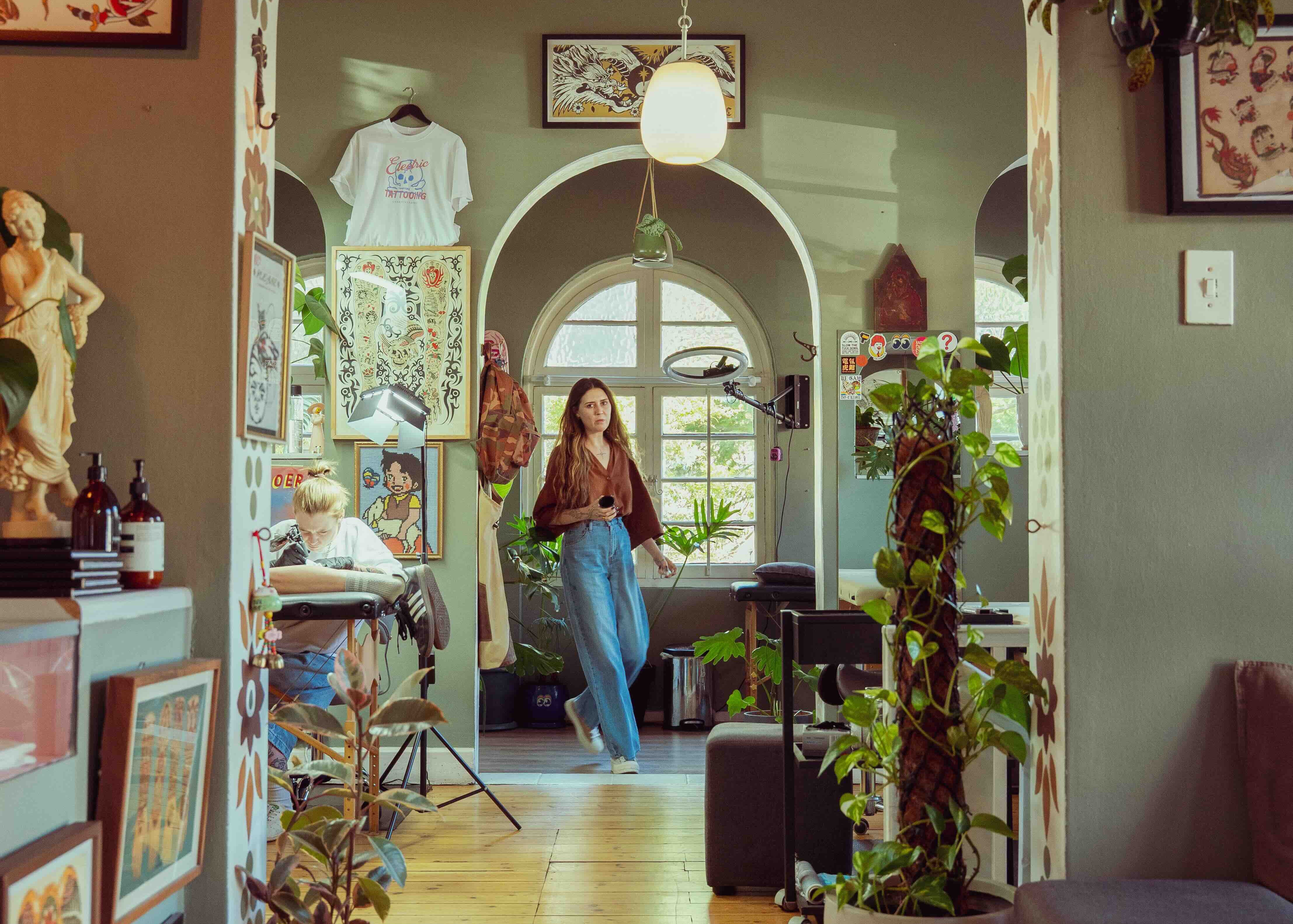 Archway leading into a cozy living room with decor and plants.